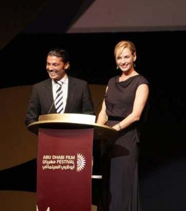US actress Uma Thurman shares a laugh with Egyptian actor Khaled Nabawy as they present the Black Pearl awards during the closing ceremony of the Abu Dhabi International Film Festival