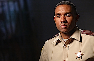 Kent Faulcon as Deputy Johnson in the horror film 