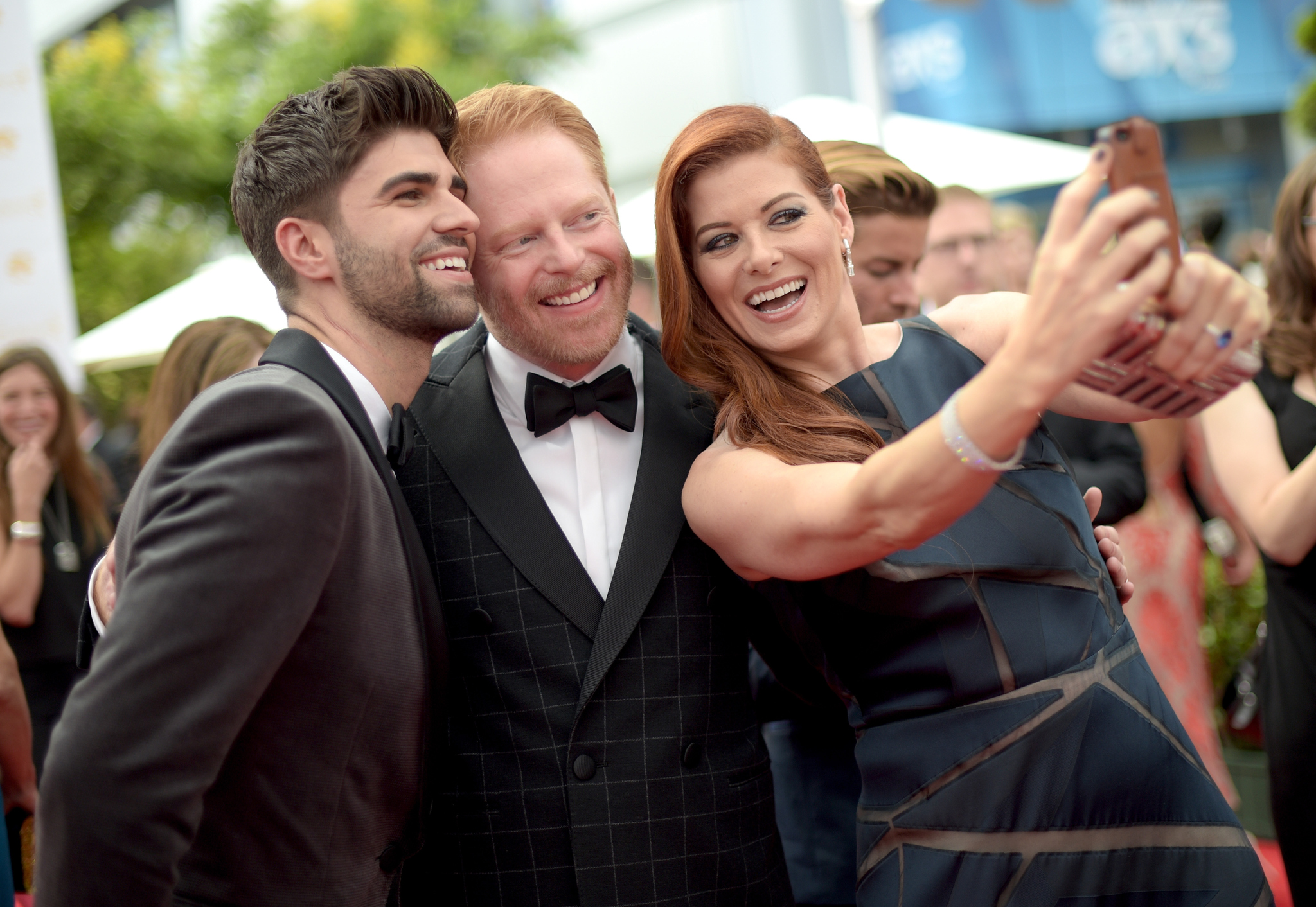 Debra Messing, Jesse Tyler Ferguson and Justin Mikita at event of The 66th Primetime Emmy Awards (2014)