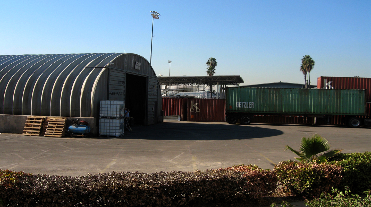 Standoff - Quonset Hut erected on empty lot and dressed inside and out. Including all shipping containers.