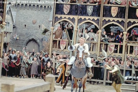 Amid the adrenaline-charged cries of spectators-including (from left to right, background) Kate (Laura Fraser), Chaucer (Paul Bettany) and Roland (Mark Addy), aspiring knight William (Heath Ledger, foreground) rides into fame