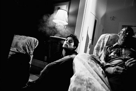 Rod (Drew Fuller) enjoys a quiet smoke as he considers the mutilated body of Rick Wendorf (David Wells)
