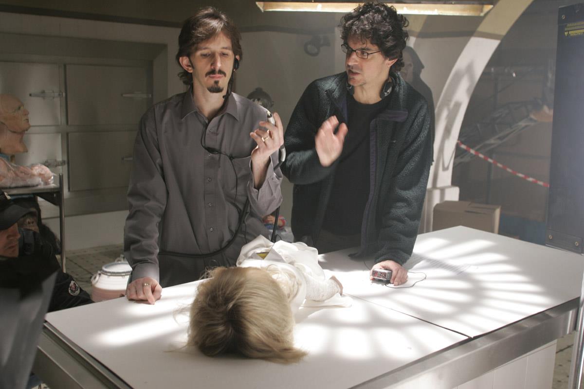 SEED OF CHUCKY: Behind the scenes: Writer / Director Don Mancini (R) sets up a shot where puppet supervisor and actor Tony Gardner (L) will begin to disassemble the Tiffany character in a scene from 