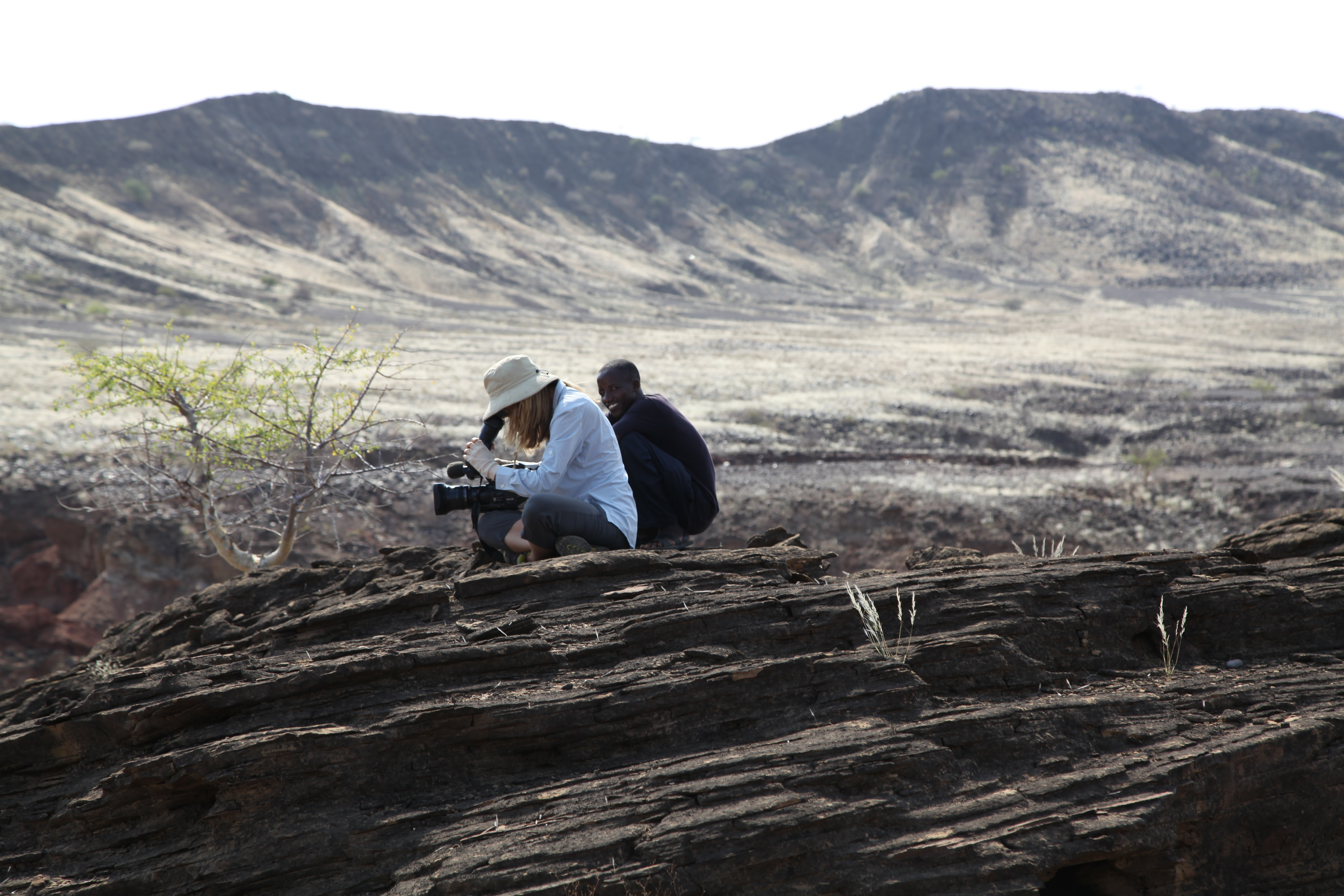 Lake Turkana Northern Kenya with camera assistant shooting archaeological dig site.