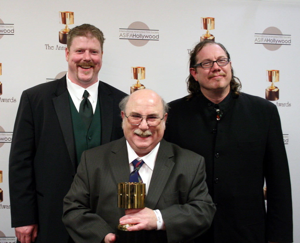Feature character animation winner Eric Goldberg with presenters John DiMaggio and Fred Tatasciore