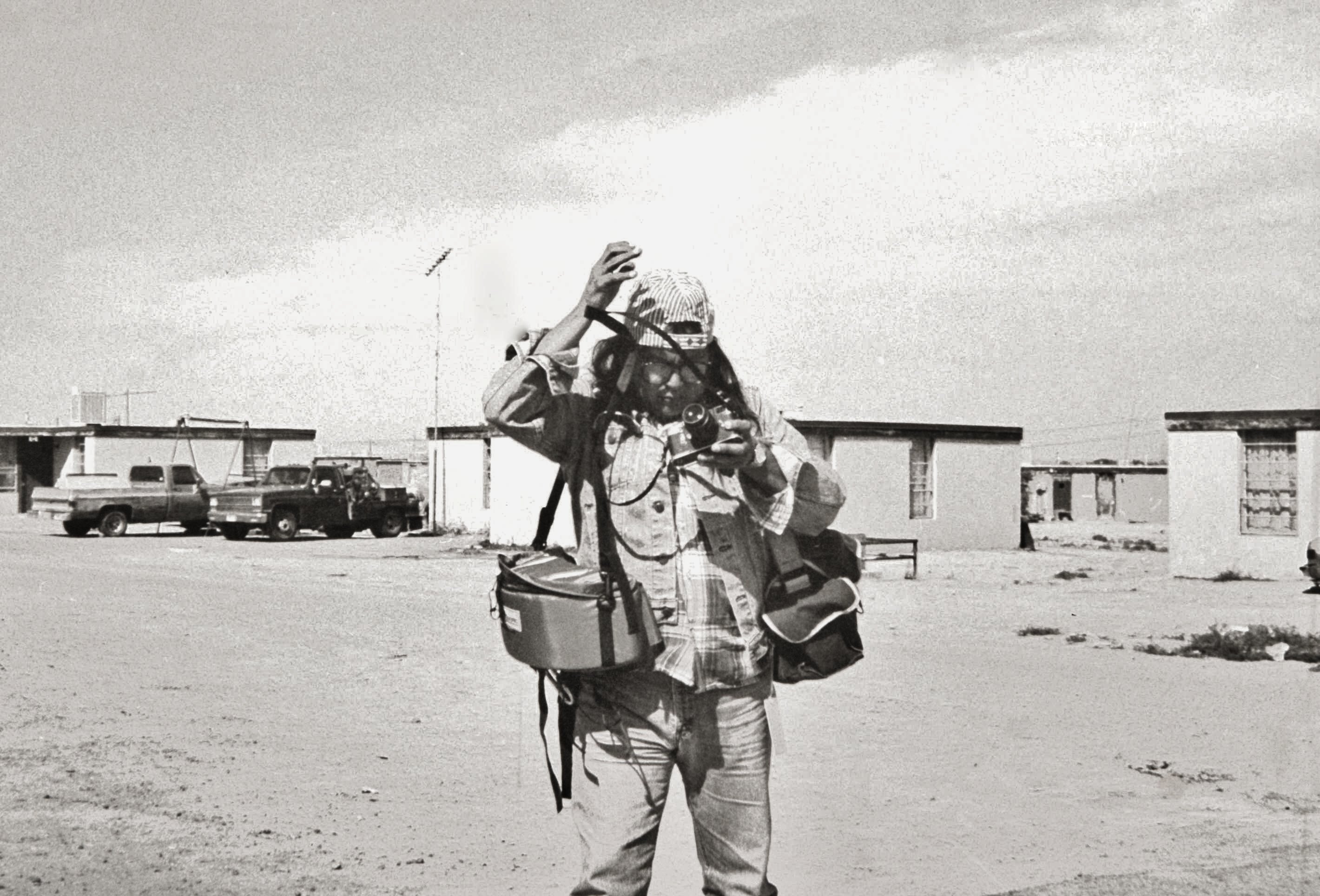 Photographer Gus among HUD housing made from uranium tailings on the Navajo Indian Reservation, Shiprock, New Mexico.