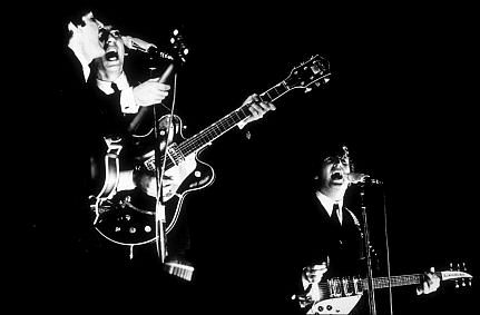 The Beatles (Paul McCartney, George Harrison, & John Lennon) in performance, 1964