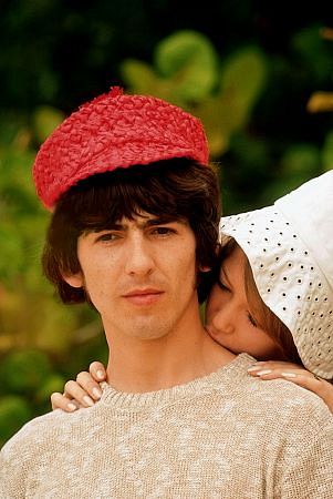 George Harrison being kissed by Pat Boyd