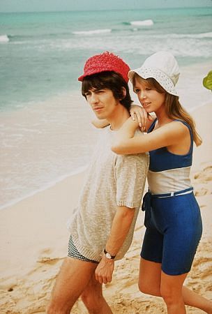 George Harrison enjoying the beach with Pat Boyd, 1964