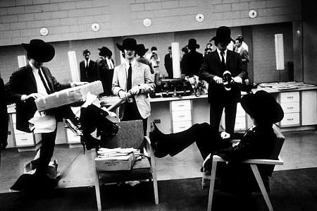 The Beatles (Paul McCartney, Ringo Starr, George Harrison, and John Lennon inside the dressing room with their cowboy hats on) c. 1964