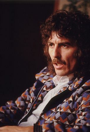 George Harrison with curly locks and a mustache, c.1980