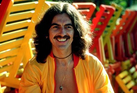 George Harrison in Acapulco posing near wooden lounge chairs, January 1977