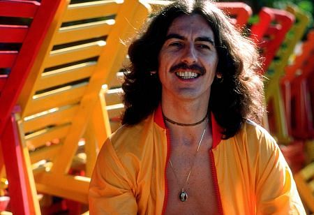 George Harrison in Acapulco posing near wooden lunge chairs, January 1977