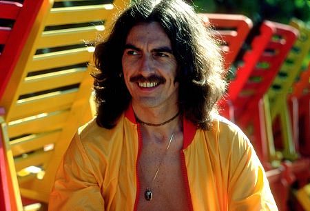 George Harrison in Acapulco posing near wooden lounge chairs] January 1977