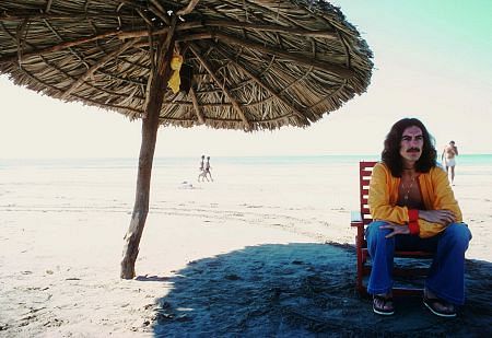 George Harrison in Acapulco enjoying the shade on the beach, January 1977