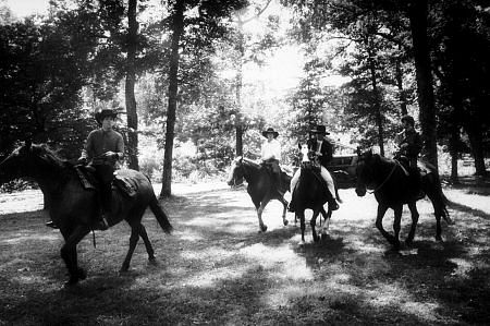 The Beatles (Paul McCartney, George Harrison, John Lennon, and Ringo Starr on horseback into the woods) in Ozarks, Arkansas c. 1965