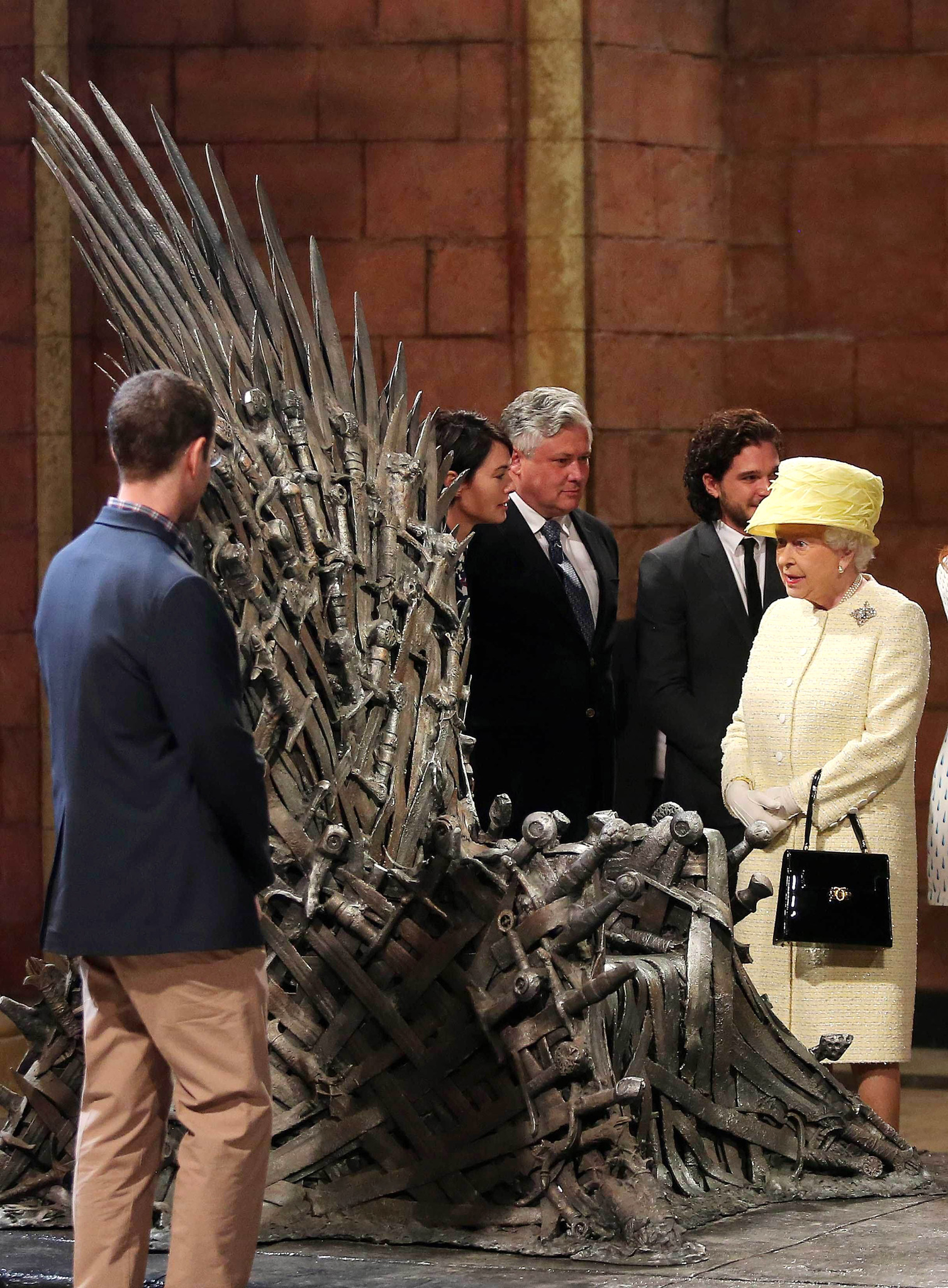 Queen Elizabeth II meets cast members of the HBO TV series 'Game of Thrones' Lena Headey and Conleth Hill as she views some of the props including the Iron Throne on set in Belfast's Titanic Quarter on June 24, 2014 in Belfast, Northern Ireland. The Royal party are visiting Northern Ireland for three days.