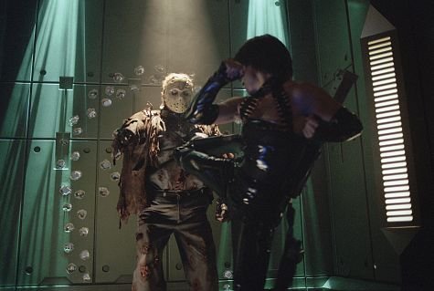 (far right) Lisa Ryder battles Kane Hodder as Jason Voorhees in New Line Cinema's, JASON X.