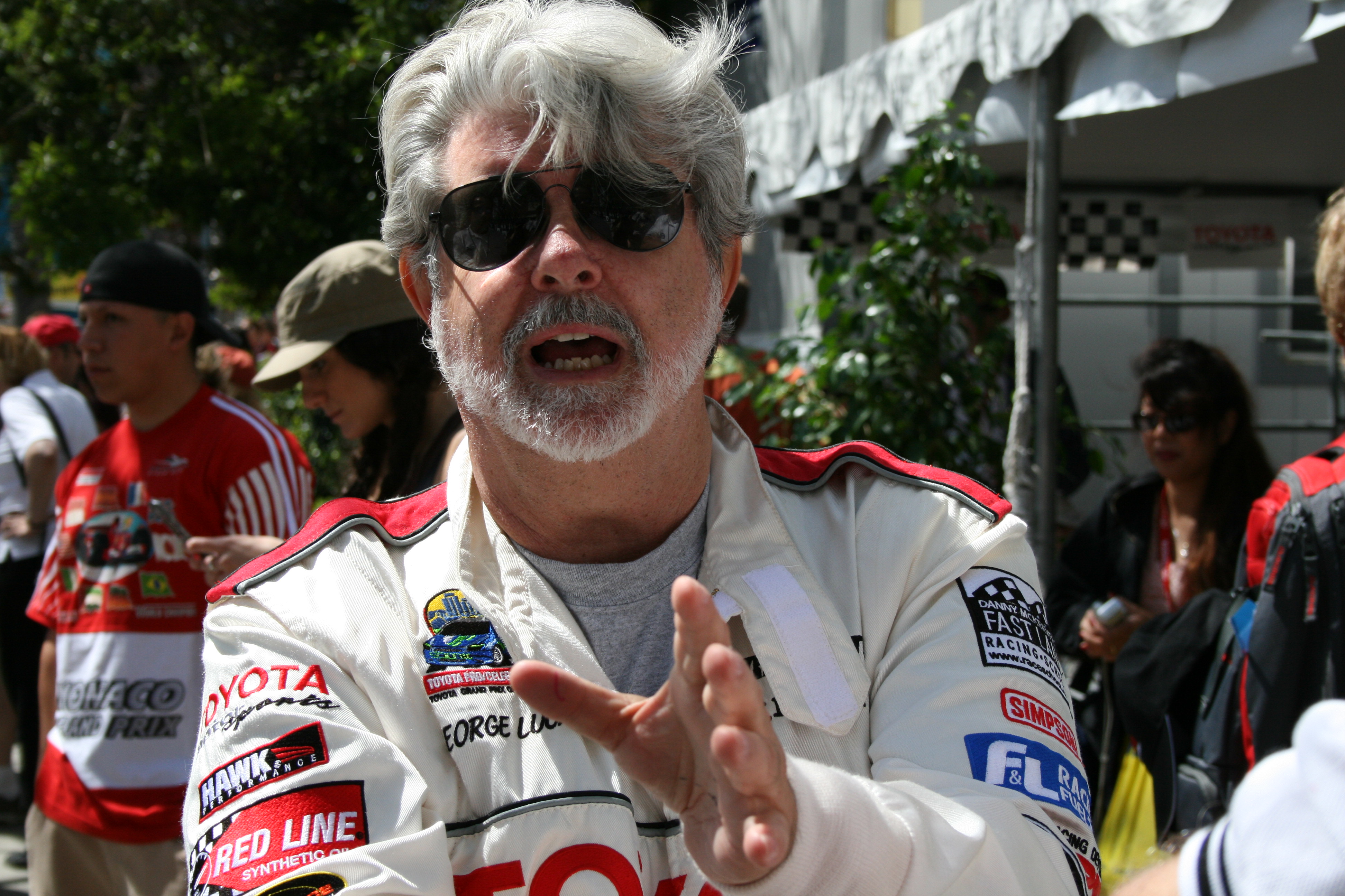 George Lucas talks shop at the LB Toyota Grand Prix Celebrity Pro Race. Sheila House field producing news package for CNN affiliate.