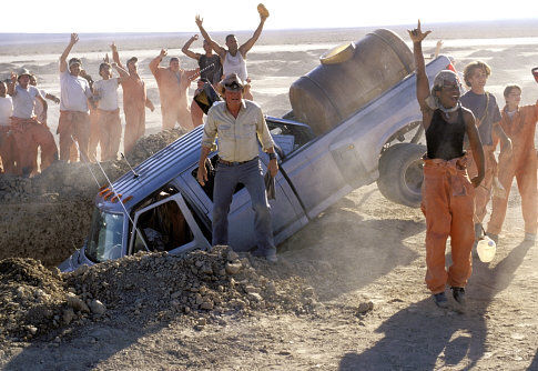 When Mr. Sir's (Jon Voight, center left) is driven into a hole, the boys of Camp Green Lake, including (center right to right) X-Ray (Brenden Jefferson), ZigZag (Max Kasch), and Twitch (Noah Poletiek), cheer.