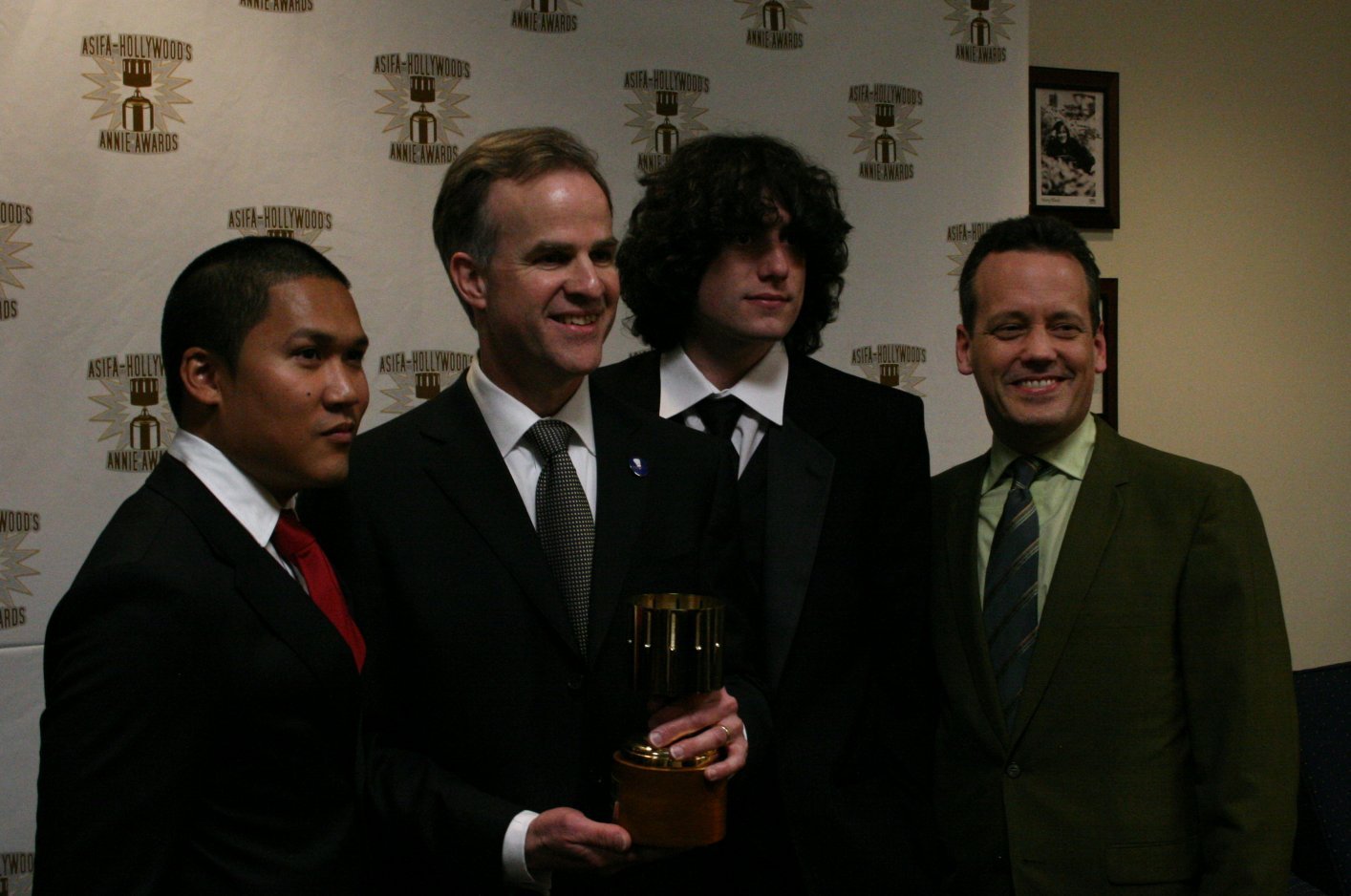 Dante Basco (l), Jack De Sena (3rd from l), Dee Bradley Baker (r) present Harley Jessup with the award for feature production design.