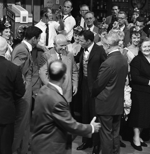 Nikita Khrushchev visits with Frank Sinatra, Maurice Chevalier, Louis Jourdan and Shirley MacLaine on the set of the film 