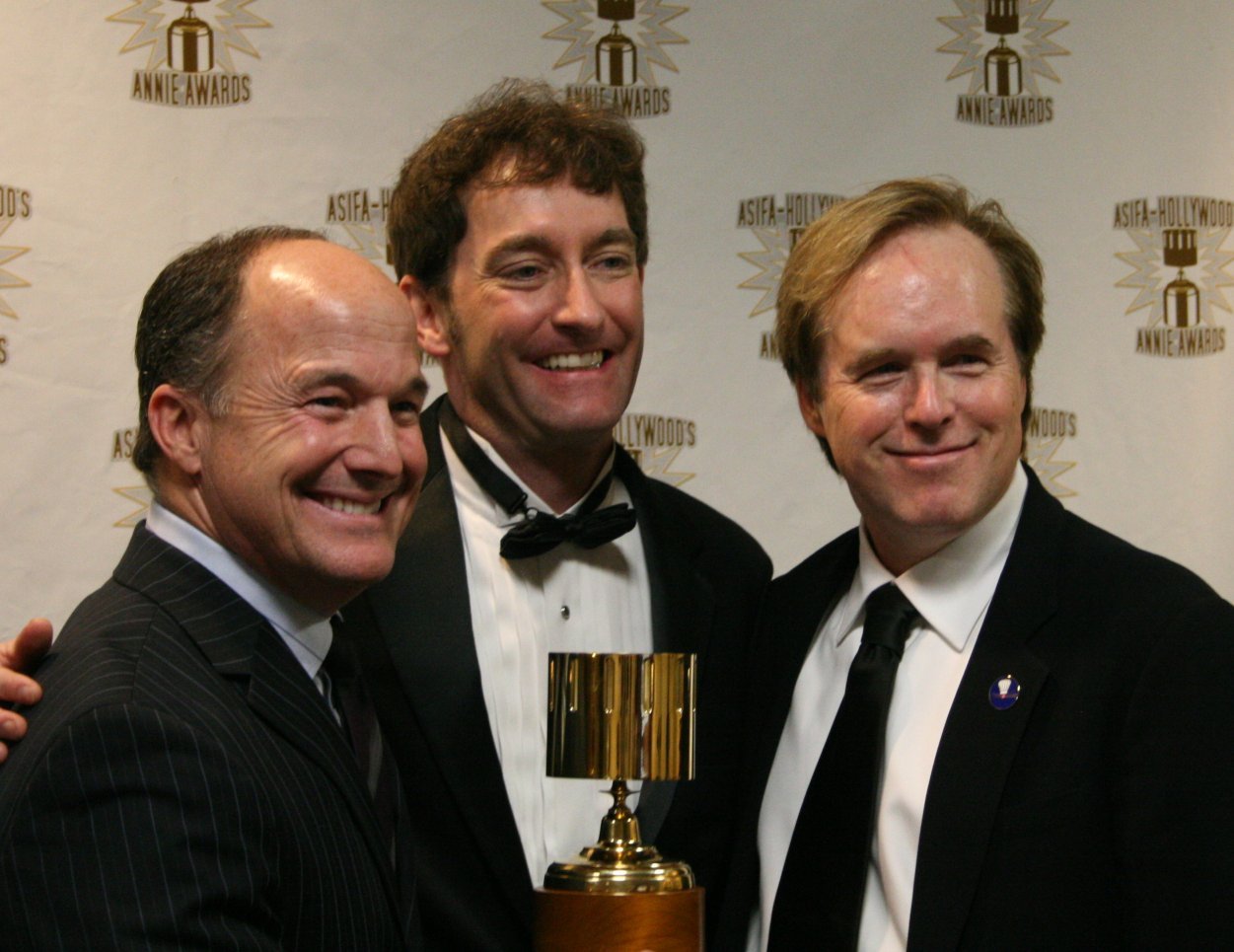 Best Feature winners Brad Lewis and Brad Bird surround presenter and event host Tom Kenny