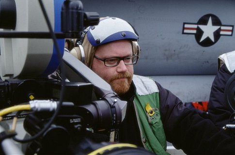 Director JOHN MOORE prepares a shot on location aboard the aircraft carrier U.S.S. Carl Vinson.