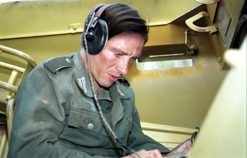 Hans (Markus Kirschbaum) writes a letter to his mother while out on tank patrol