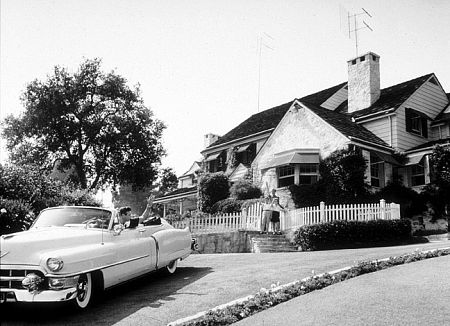 Frankie Laine in his Cadillac with his wife, Nan Grey, and children at home in Los Angeles, CA, 1954.