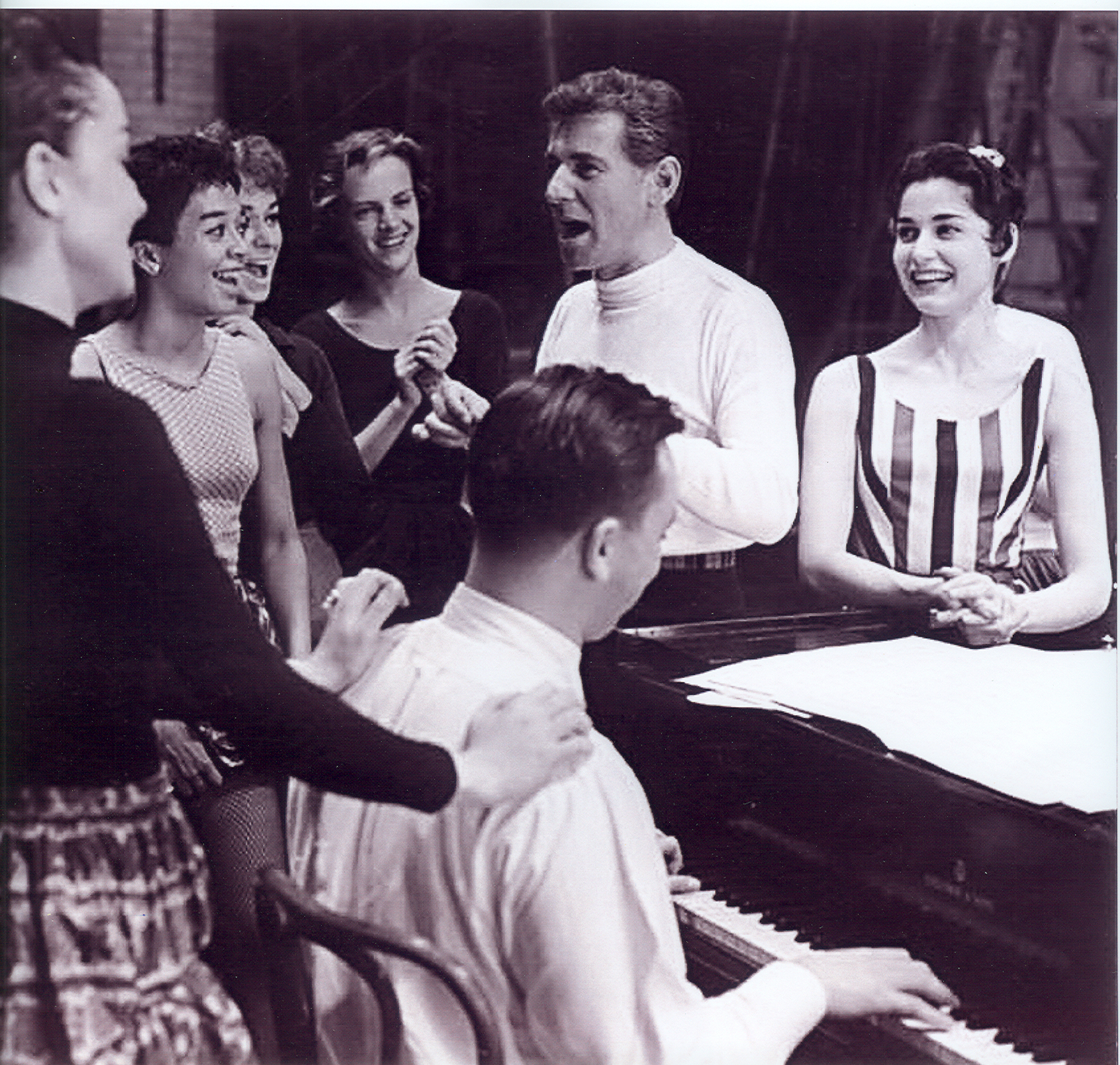 First day of rehearsal of West Side Story. To Carol's right is Leonard Bernstein. At the piano is Stephen Sondheim; Chita Rivera gives him a back rub.
