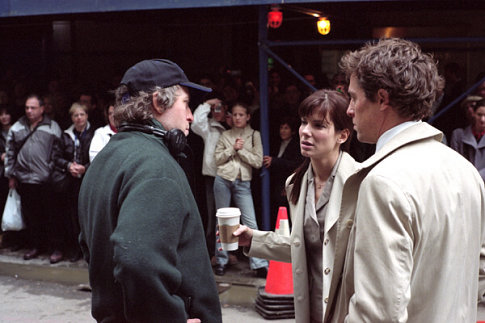 Director Marc Lawrence on the set with Sandra Bullock and Hugh Grant