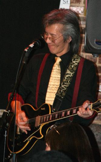 Geoff playing rock on his Les Paul guitar with the all-Asian band, The Emperor's Club, at Silk Road Cafe, Chinatown, NYC 2010