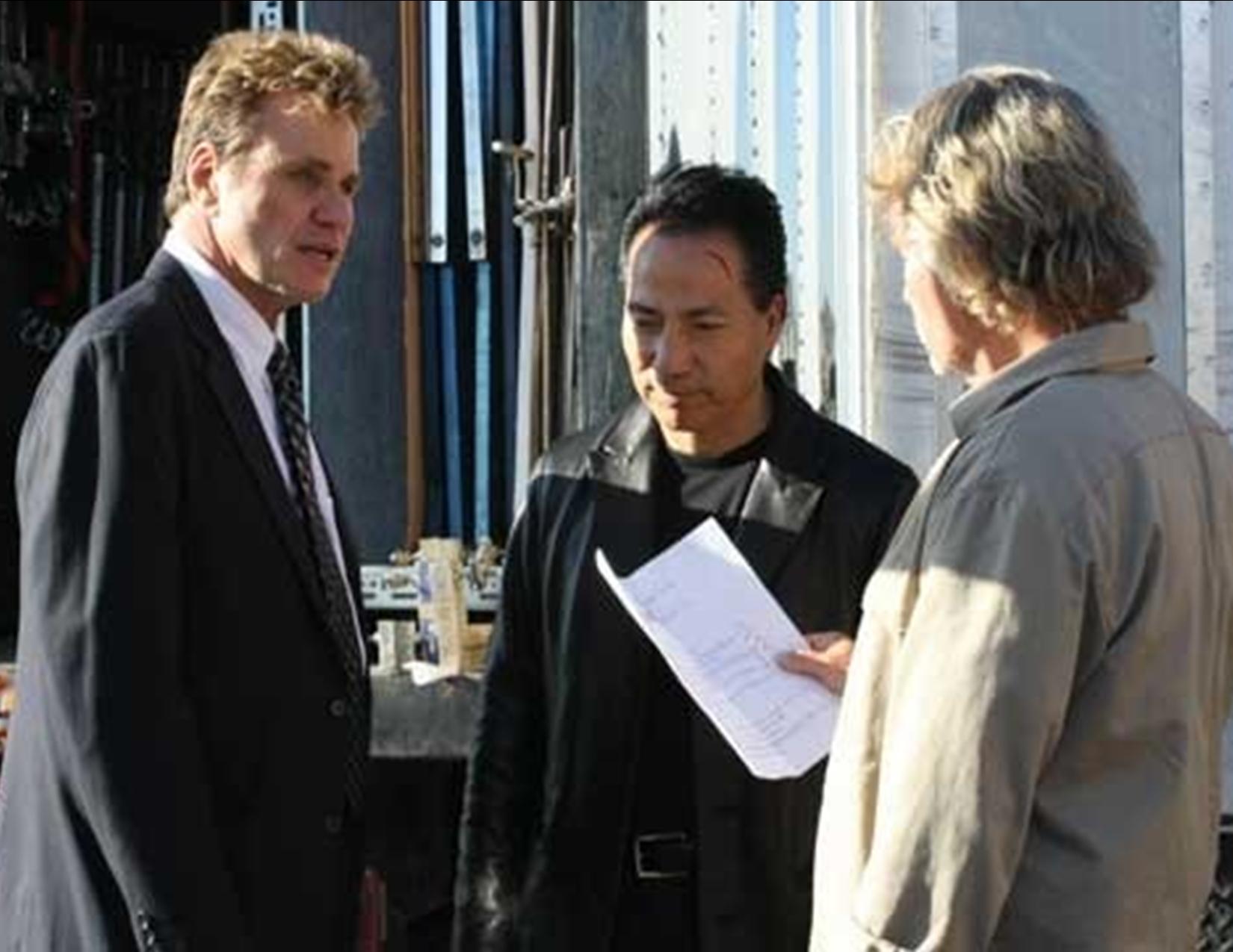 Julian Lee reviewing dialogue with Martin Kove (The Karate Kid) and John Savage (The Deer Hunter) on the set of 