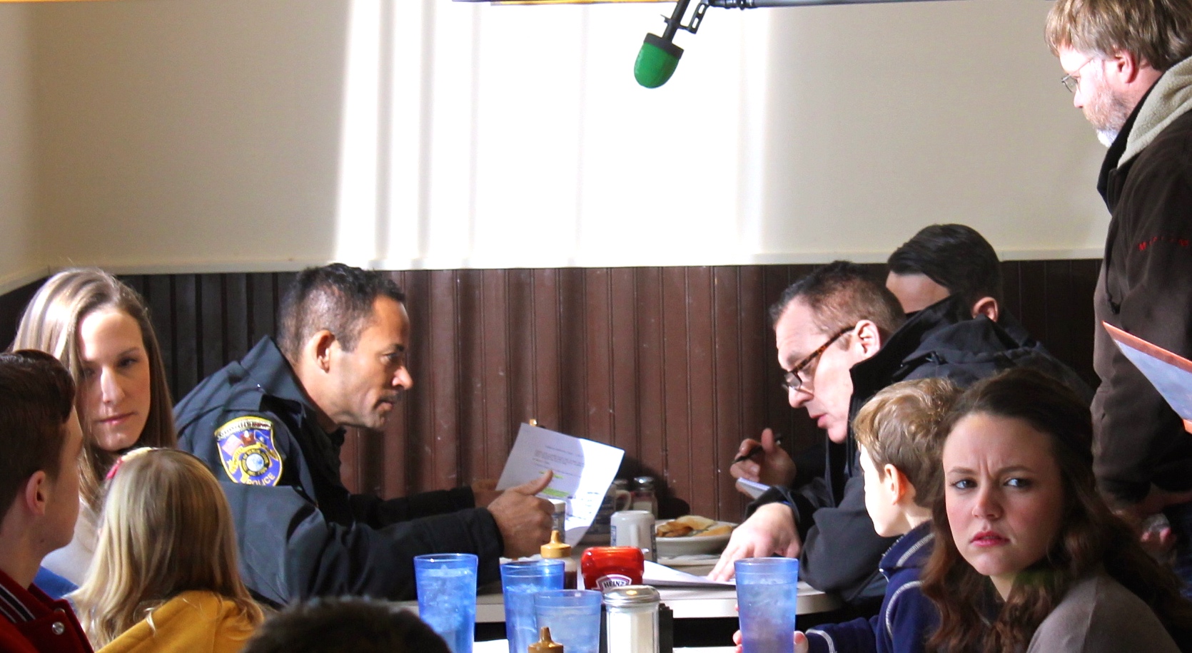 Director Jake Cooney watches Thyme and Tom rehearse on set of Blue Line