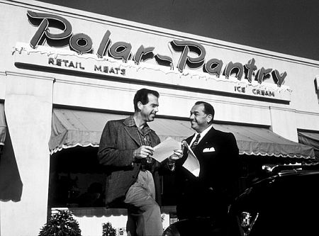 Bo Roos, business agent, with his client, Fred MacMurray, outside the Polar Pantry, 1951.
