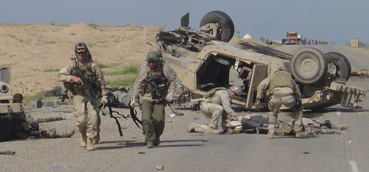 Helping wounded brothers to medivac helicopter. All five wounded men survived after the 155mm artillery round exploded in a culvert.