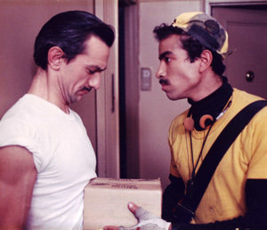 Jimmy (Robert Bland) hands off a package to the Client (Joe Manuella) in the film 
