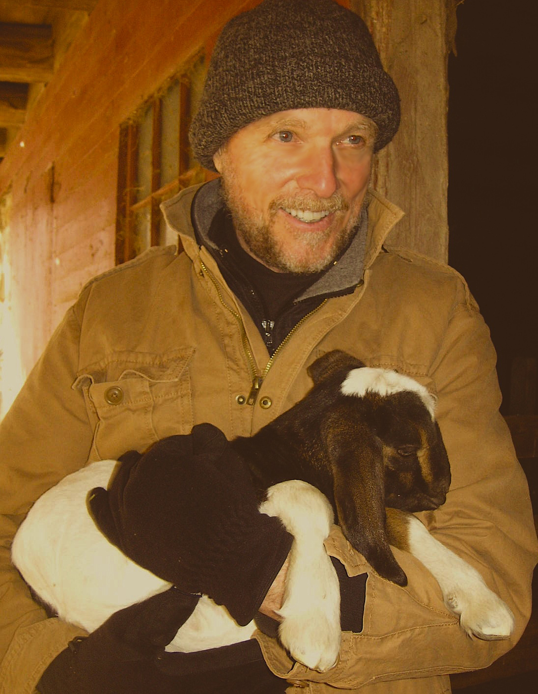 While visiting a farm on chilly day - this baby goat was shivering. William cuddled the goat until it stopped shivering and feel asleep in his arms.