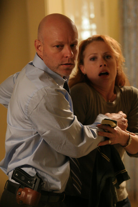 Detective Paul Grunning (James Macdonald) protects his wife (Scarlett McAlister).