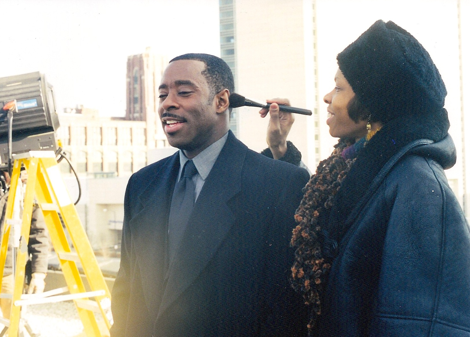 Cat'Ania McCoy-Howze, Makeup Department Head with Courtney B. Vance for Love and Action in Chicago. She removes the shine on the back of the head for an over-the-should camera shot