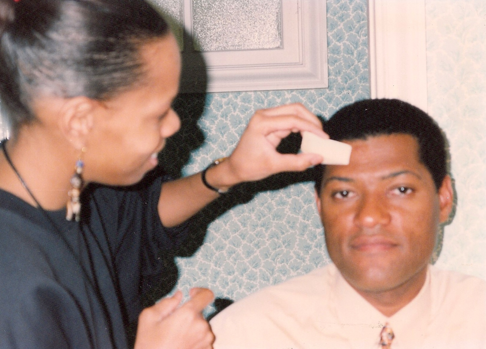 Cat'Ania McCoy-Howze, Makeup Arist applying makeup on actor Laurence Fishburne for a What's Love Got to Do With It Promo.