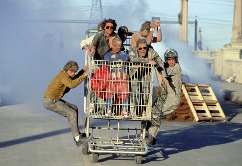 (left) Dave England, (right) Ehren McGhehey, (in shopping cart, beginning center clockwise) Jason 