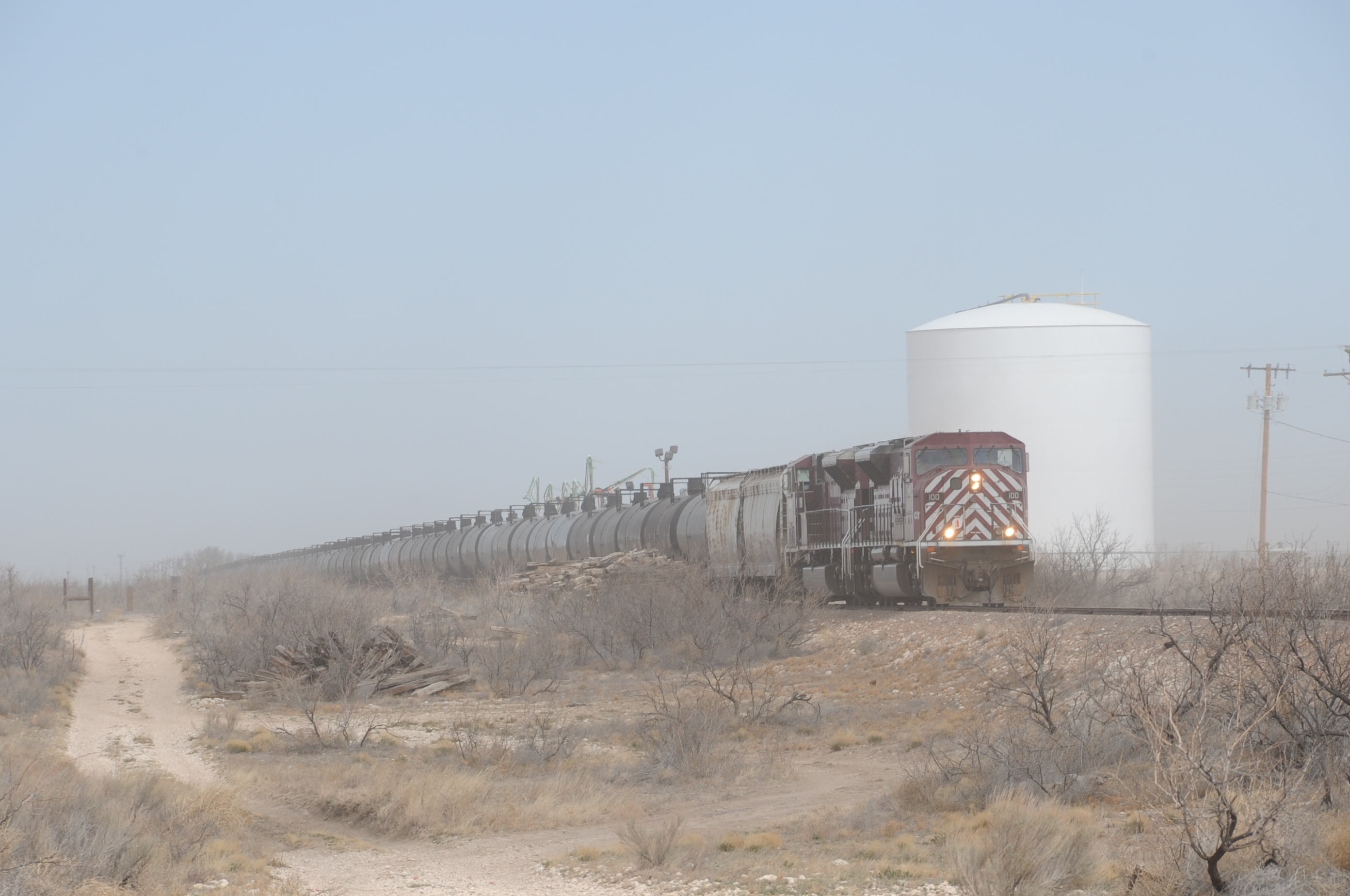 2013. Texas - New Mexico Railroad. A 79-car crude oil unit train moves south near Hobbs, NM, heading for the UP interchange at Monahans, Texas. Yes, that's blowing dirt enshrouding the train.