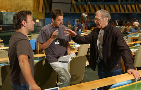 (L to r) Producer KEVIN MISHER, Producer TIM BEVAN and Director/Executive Producer SYDNEY POLLACK on the floor of the General Assembly during filming of The Interpreter, a suspenseful thriller of international intrigue set inside the political corridors of the United Nations and on the streets of New York.