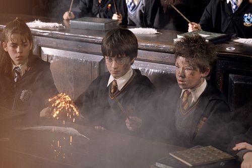 Harry Potter (DANIEL RADCLIFFE) looks on in shock while Seamus (DEVON MURRAY) is surprised by the sudden explosion of his wand