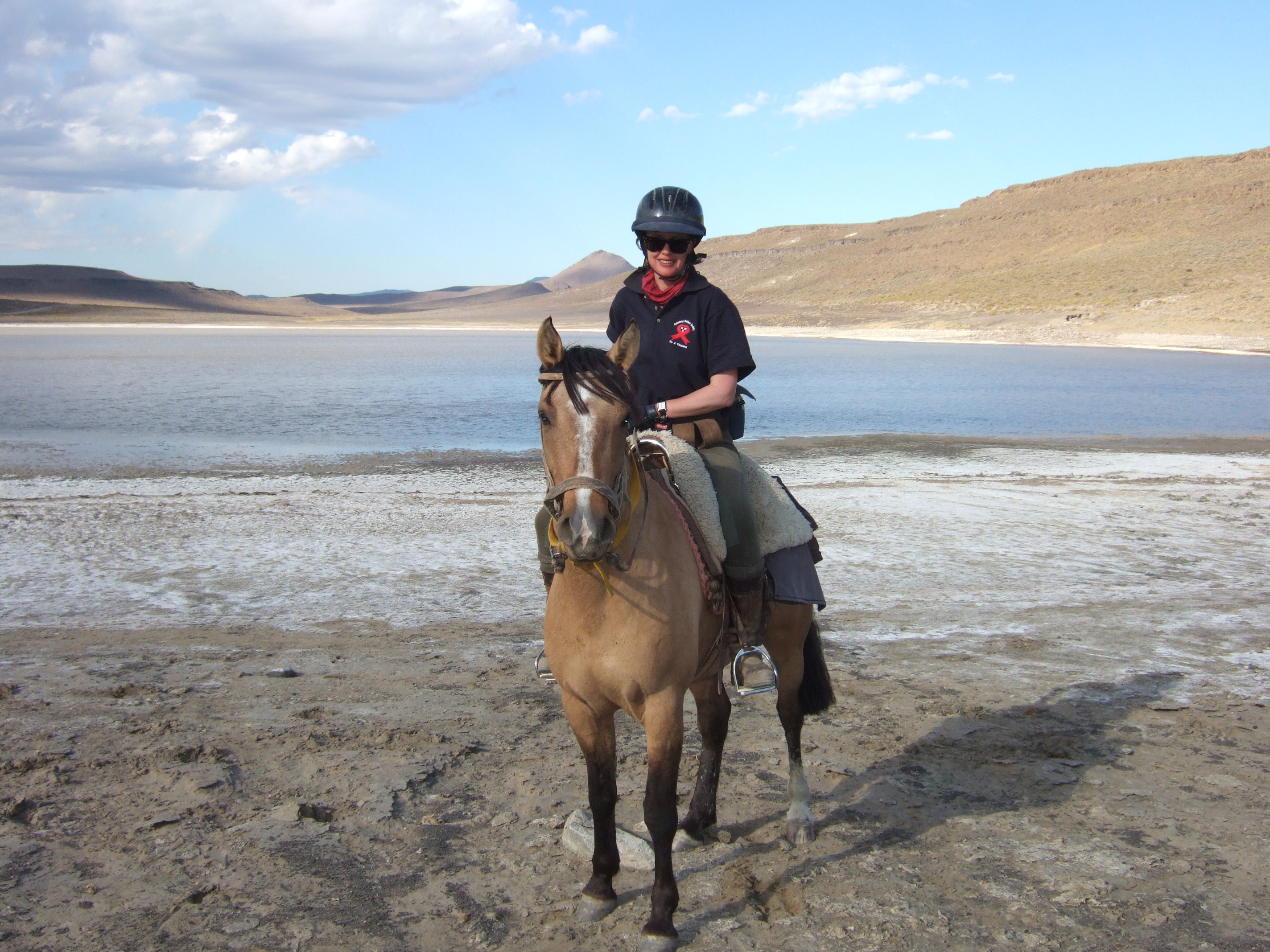 Sophie Neville at a salt lake in Argentia whilst riding across South America to raise funds to combat HIV/AIDS