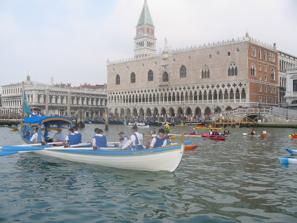 Sophie Neville filming aboard The Draper's Schallop at St Mark's Square in Venice. Olympic Gold Medalist Ed Coode is rowing stroke.