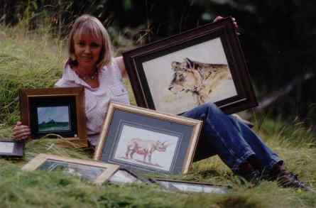 Sophie Neville with a selection of her paintings of birds, landscapes and African wildlife.