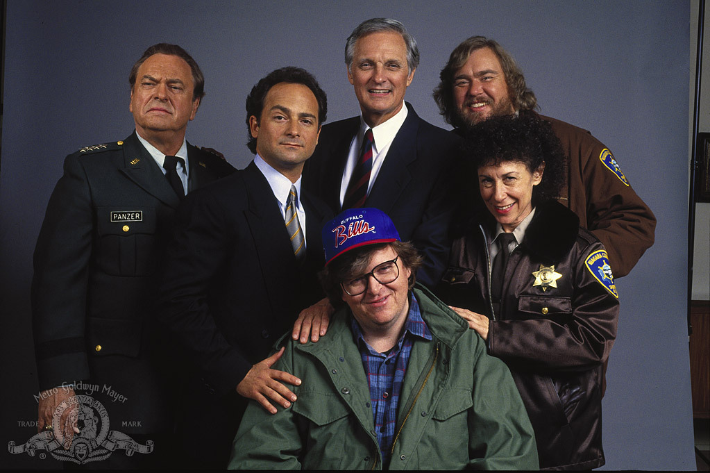 Still of Alan Alda, John Candy, Kevin Pollak, Rip Torn, Michael Moore and Rhea Perlman in Canadian Bacon (1995)